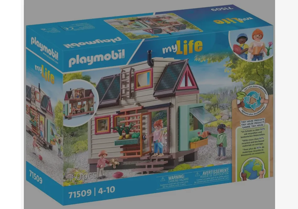 Opakowanie zestawu klocków Playmobil z serii myLife o numerze 71509. Na pudełku widoczny jest model małego domu na kółkach (tiny house) z drewnianą elewacją, dużymi oknami i tarasem. Wokół domu znajdują się figurki ludzi oraz roślinność. Na opakowaniu widnieją napisy: 'playmobil', 'myLife', '160pcs', '71509 | 4-10' oraz ostrzeżenia o dławieniu w języku angielskim i francuskim. W prawym górnym rogu znajduje się logo myLife oraz ilustracje postaci.